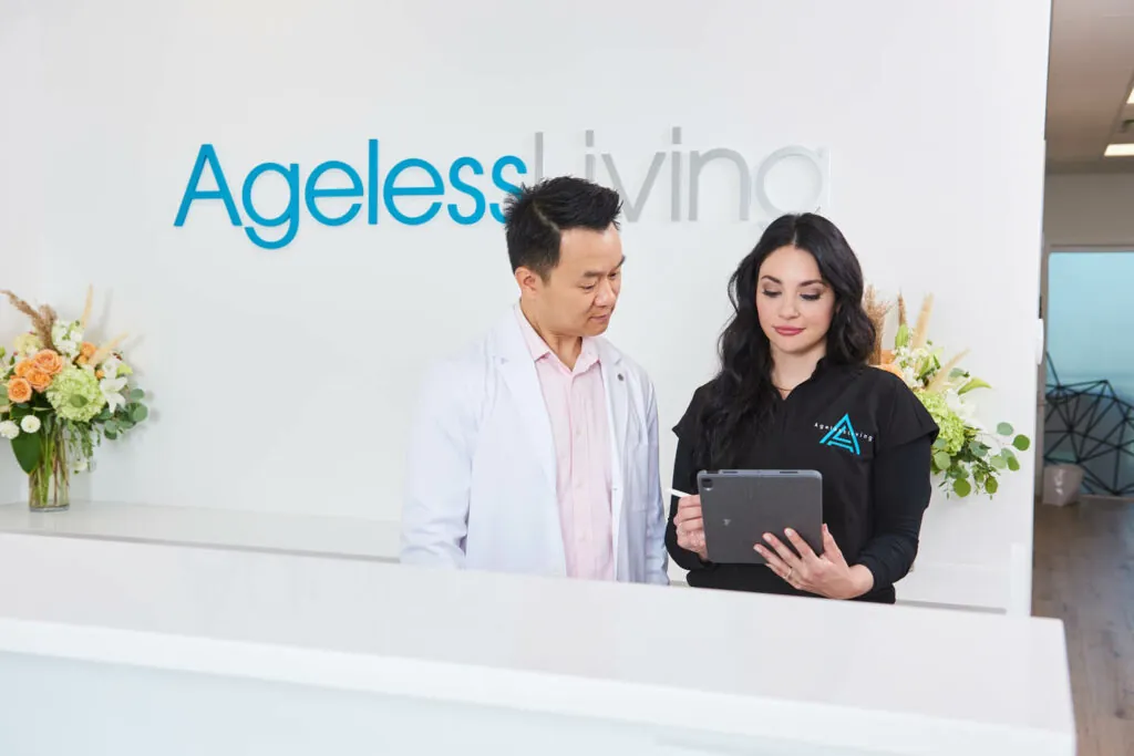 An Ageless Living physician and clinician working together beneath the clinic sign