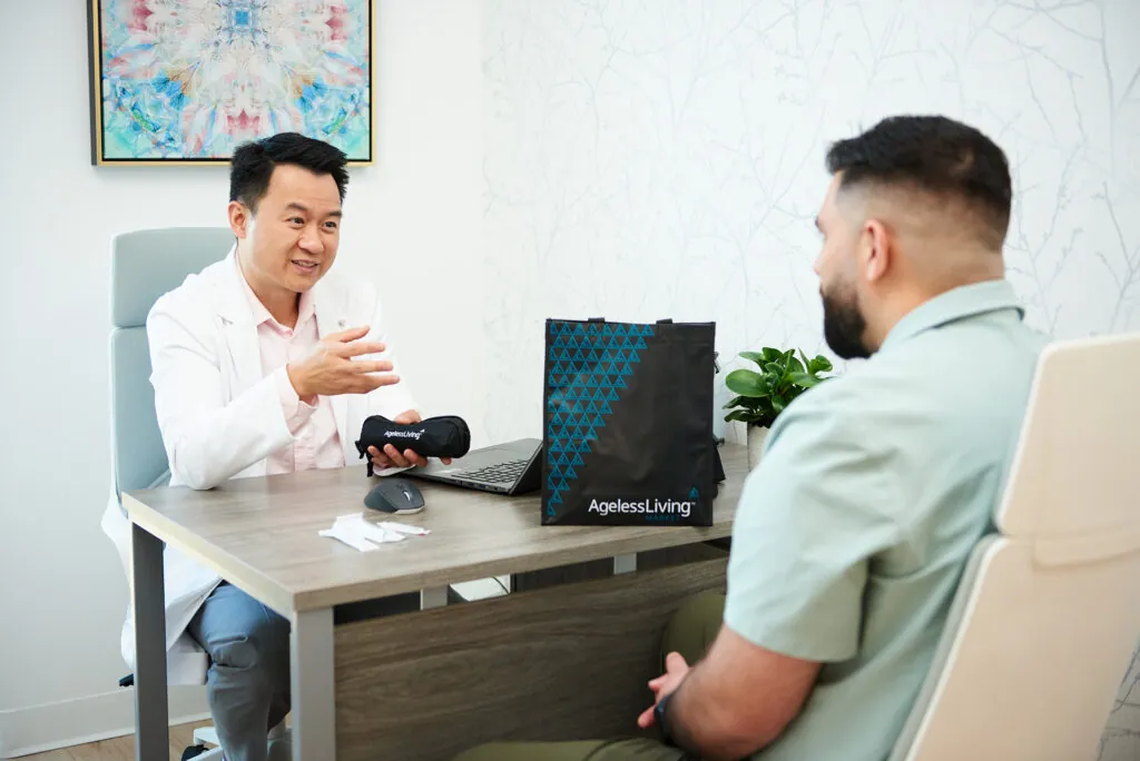 A physician talking a patient through a treatment plan at his desk